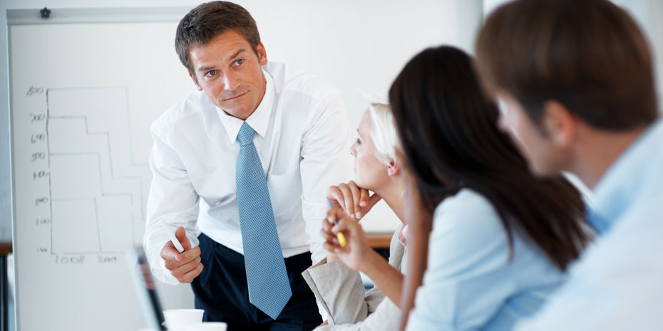 Portrait of smart young businessman discussing with his colleagues during a presentation at office